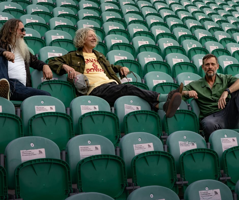 Three festival cast members sitting in empty stadium seats at RoseShire Festival.