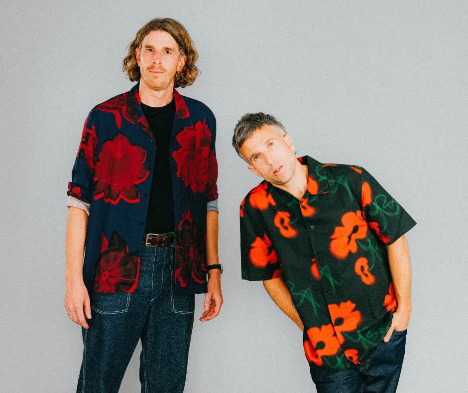 The Hoosiers band members performing at RoseShire Festival, showcasing vibrant floral shirts and liv.