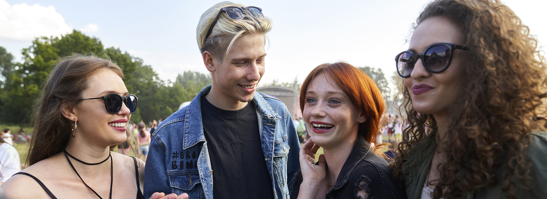 Group of young caucasian friends chatting and having fun on music festival Group of young caucasian friends chatting and having fun on music festival